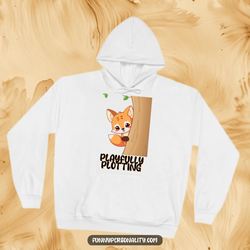 Funny and cozy hoodie featuring a playful cartoon fox peeking around a tree with a mischievous grin.