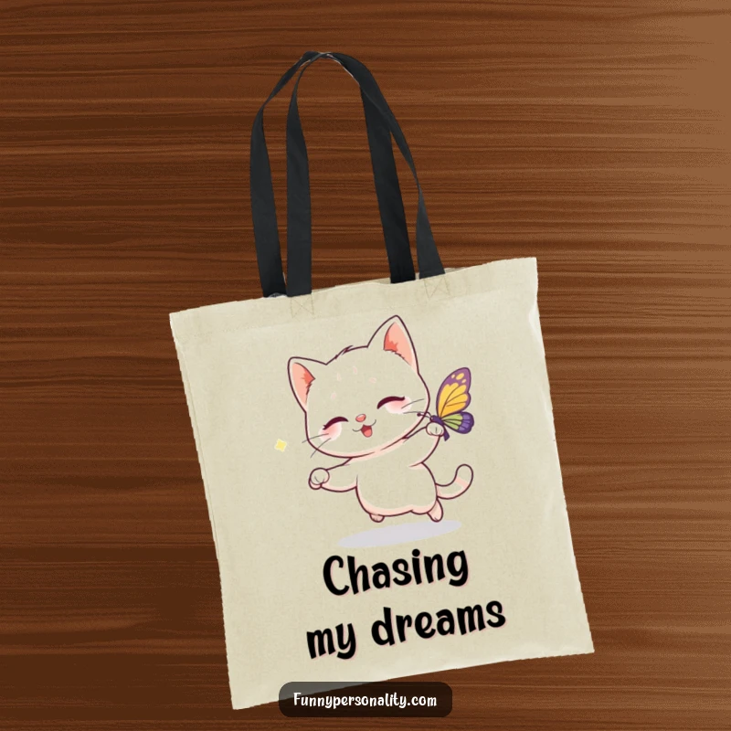 Funny tote bag featuring a playful cat character chasing a sparkling butterfly, a practical and humorous accessory for everyday use.